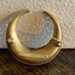 The makers mark on the back of the pin found on the Fortuny.